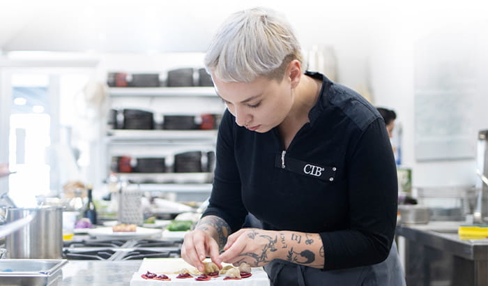 Healthy cooking course student plating up